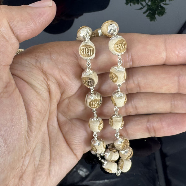 "Radha Naam Tulsi Mala with pure silver elements, crafted from sacred Tulsi beads with elegant spiritual detailing."