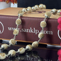 "Radha Naam Tulsi Mala with pure silver elements, crafted from sacred Tulsi beads with elegant spiritual detailing."