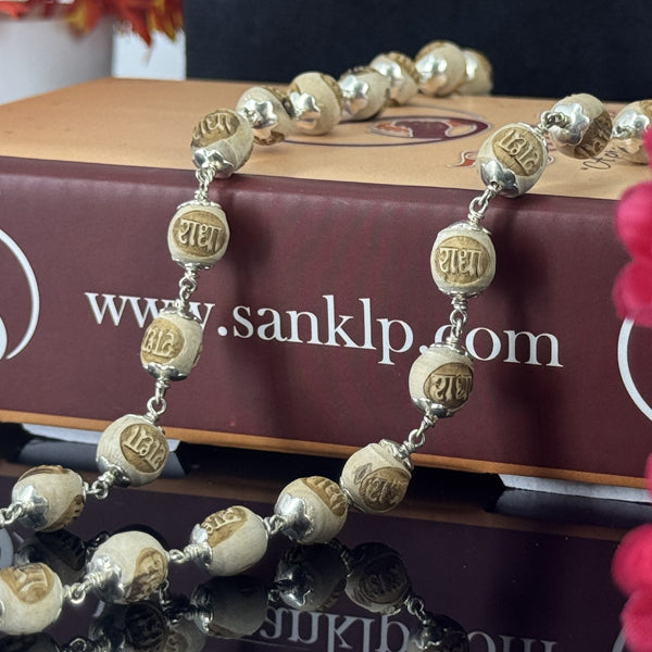 "Radha Naam Tulsi Mala with pure silver elements, crafted from sacred Tulsi beads with elegant spiritual detailing."