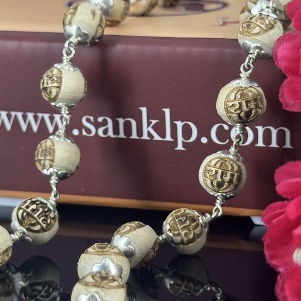 "Radha Naam Tulsi Mala with pure silver elements, crafted from sacred Tulsi beads with elegant spiritual detailing."