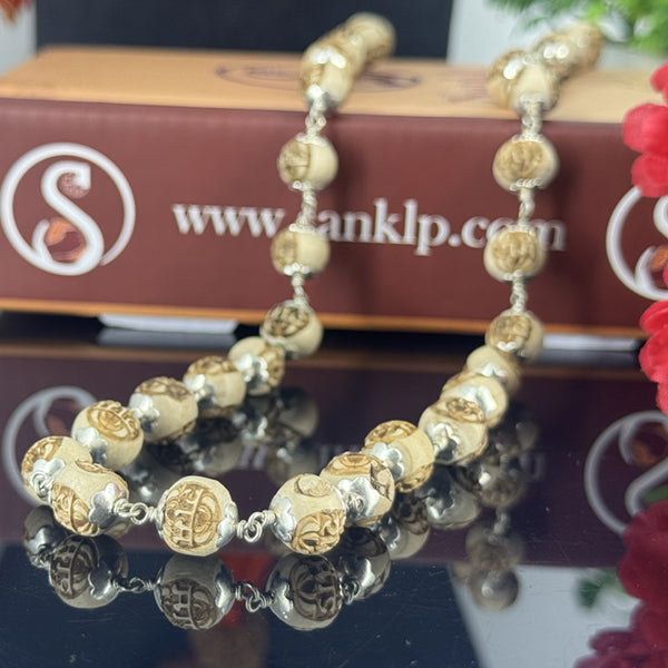 "Radha Naam Tulsi Mala with pure silver elements, crafted from sacred Tulsi beads with elegant spiritual detailing."